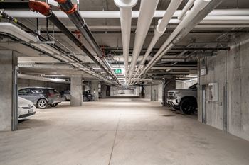 an empty parking garage with cars parked in it